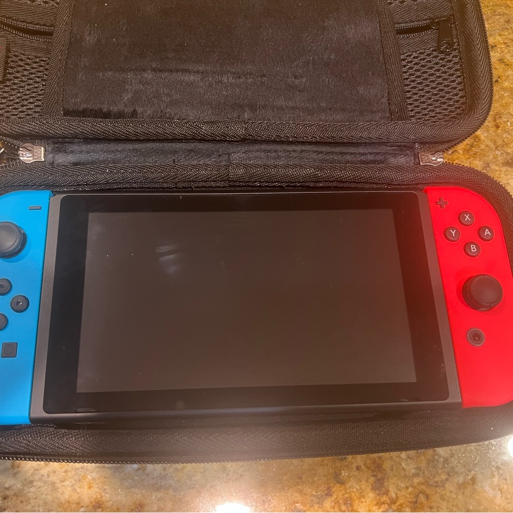 Nintendo Switch with games, case, and accessories.